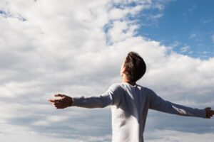 person holds his arm outstretched while embracing acceptance in recovery