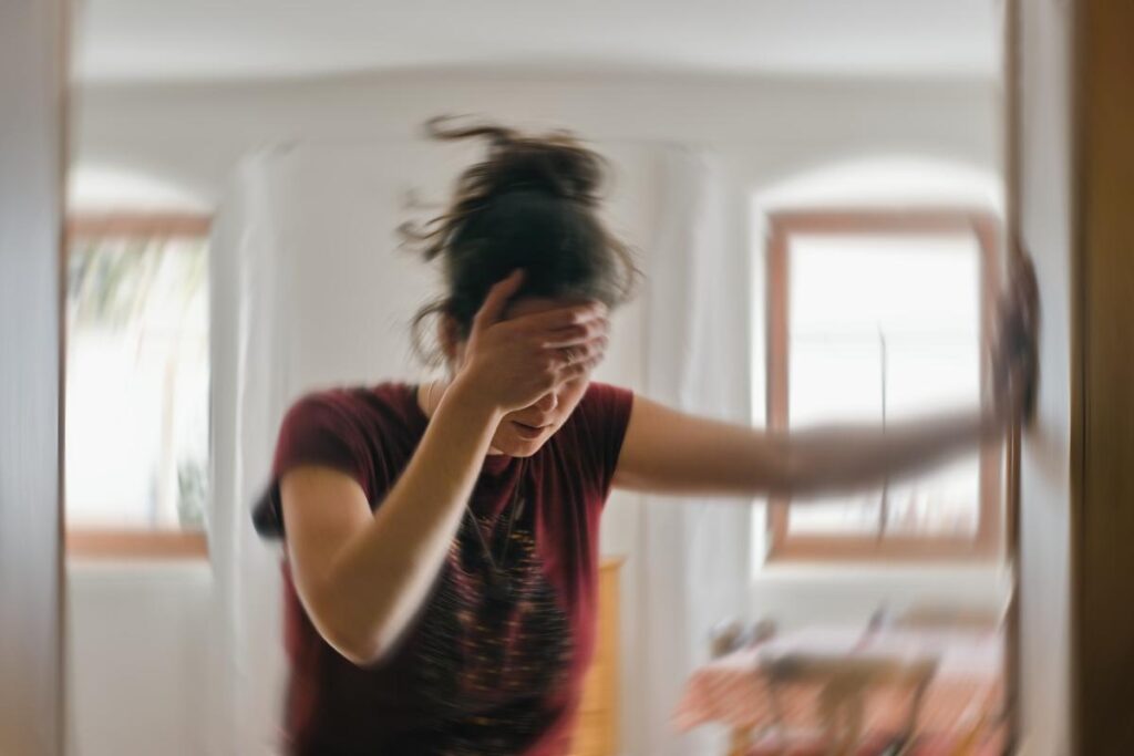 distraught woman holds her hand to her forehead while wondering what are the long-term effects of shrooms