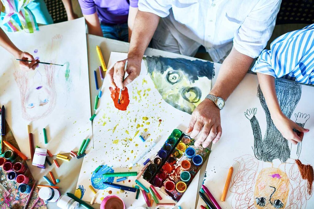 person paints while participating in one of their many art therapy activities