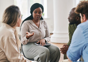 a woman speaks to a group about substance abuse treatment in mississippi