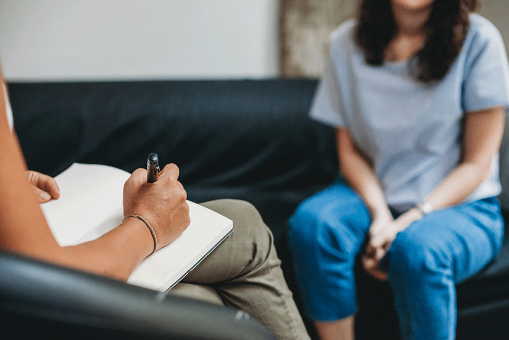 young woman talking to behavioral health speciialist wondering does TRICARE cover therapy