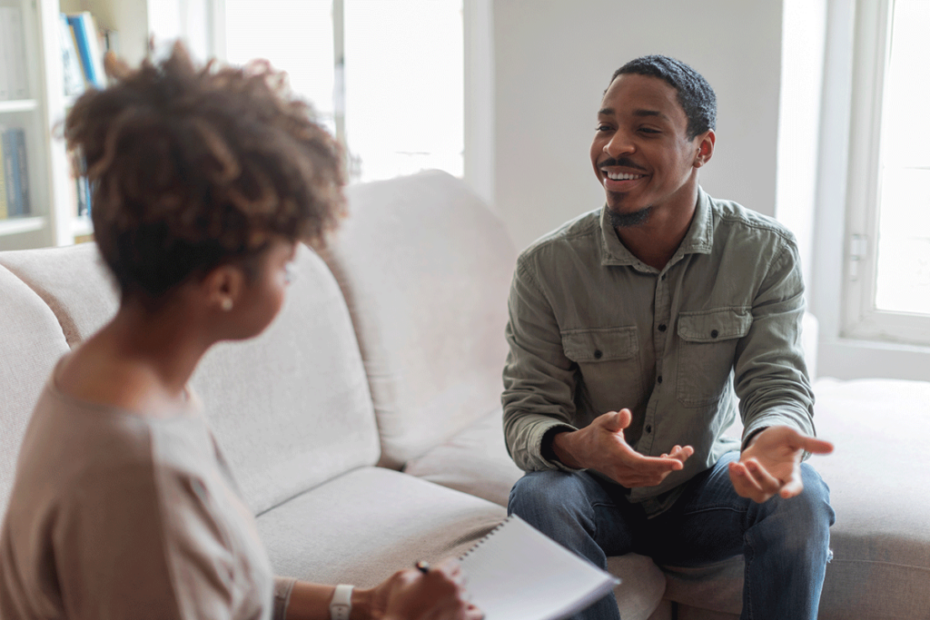 young man talking to behavioral health specialist and asking what is motivational interviewing?