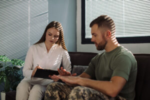 a therapist talks to a man about the hardships of military ptsd and how to get help